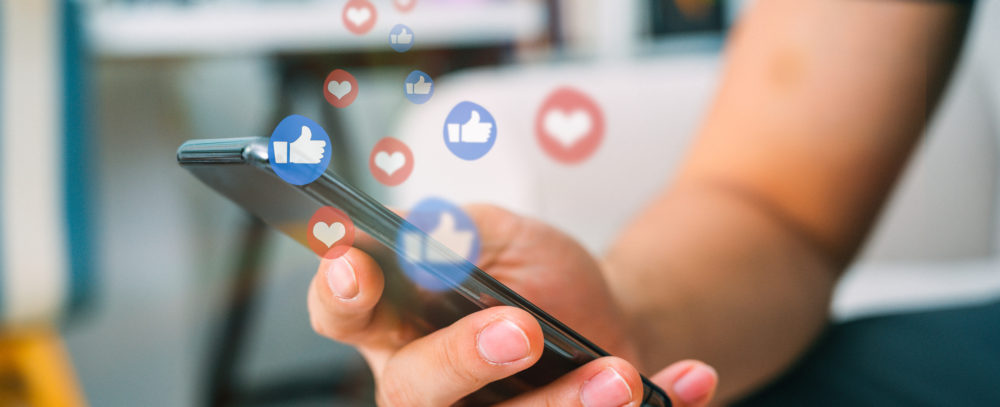 Hand using smart phone with Social media concept